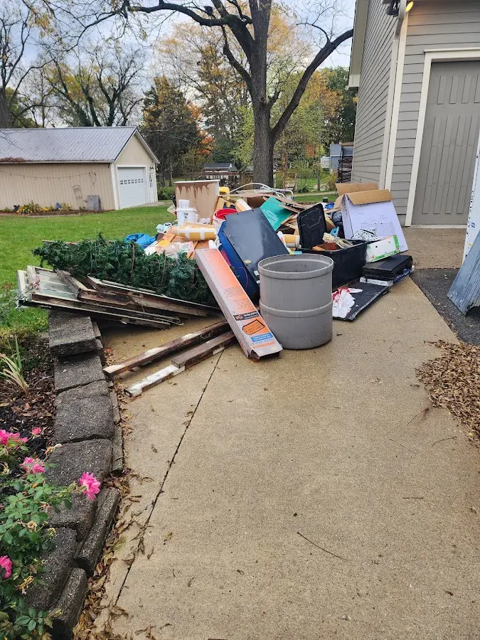 Dumpster being loaded with debris for Roofing Dumpster Rental in Canton